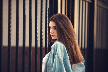 Beautiful tourist girl on city street. Gorgeous young model woman outdoor portrait. Fashionable wear.の写真素材