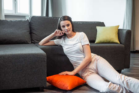 Young woman pretty relaxing on couch in living room. Casual style indoor shoot