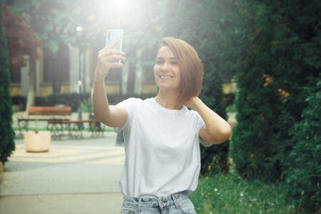 Hipster girl casual wear. Summer city portrait. Young tourist woman walks in townの写真素材
