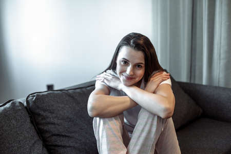 Young woman pretty relaxing on couch in living room. Casual style indoor shootの写真素材