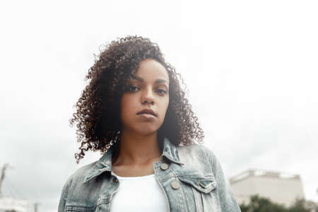 Black young pretty girl relaxing outdoor. Street hipster portrait. Walking student womanの写真素材
