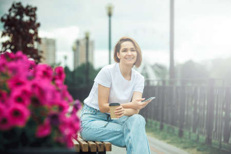 Stylish young woman in urban scene with mobile phone. Hipster trendy modelの写真素材