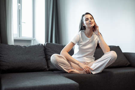Young woman pretty relaxing on couch in living room. Casual style indoor shootの写真素材