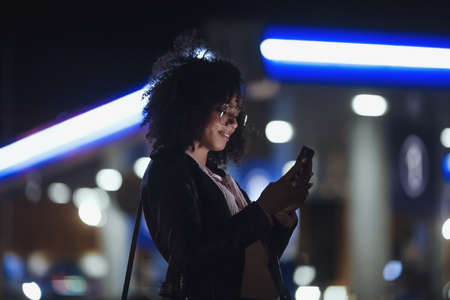 Night portrait of beautiful fashion young african american girl. Cute curly modelの写真素材