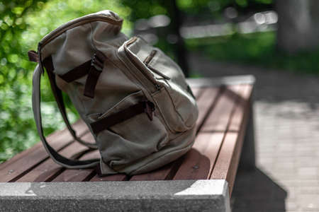 Vintage backpack on sunny city street. hipster travel bag