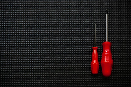 Red screwdrivers on black background. Work industrial concept