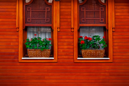 windows and flowers. wooden house wall. country styleの写真素材