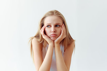Funny student girl portrait on white background. Grimacing emotion model. Studio portrait