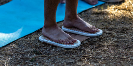 Feet on sharp nails sadhu board. Yoga meditation exerciseの写真素材