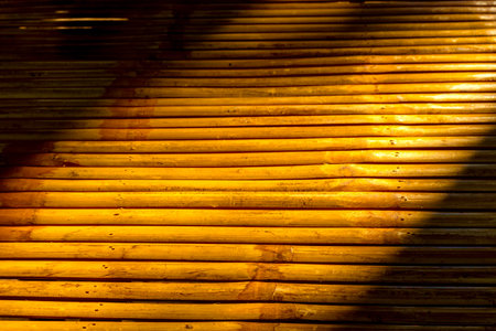 Bamboo table surface in sunset light. Abstract texture backgroundの写真素材