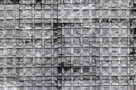 Industrial concrete grid texture with weathered steel reinforcements.の写真素材