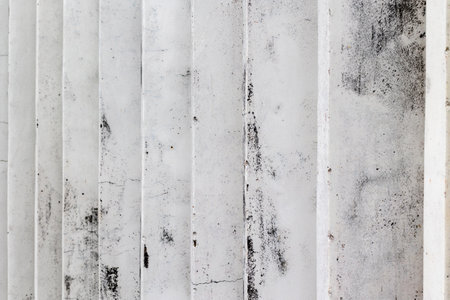 Abstract close-up of weathered white concrete staircase with textured surface.の写真素材