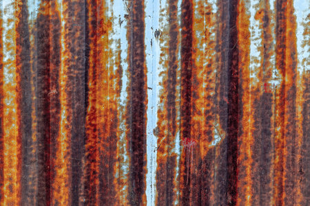 Weathered rusty metal with vertical stripes and patina texture.の写真素材
