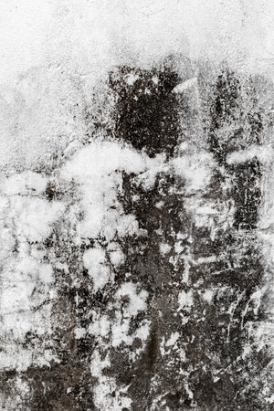 Weathered textured surface with white and dark patterns in abstract design.の写真素材