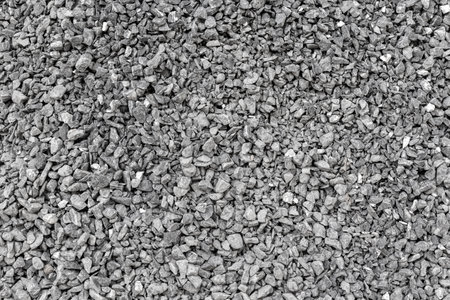Close-up of gray gravel stones in a uniform texture.の写真素材