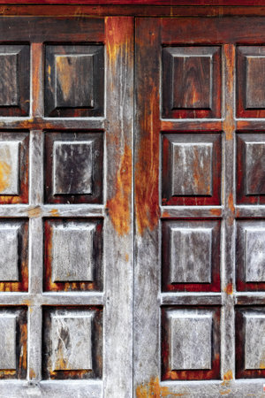 Ancient wooden door with weathered texture and rich rustic colors.の写真素材