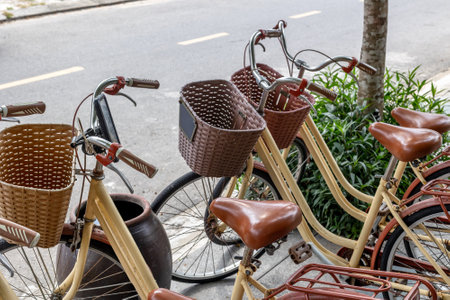 Vintage bicycles with baskets parked on urban street.の写真素材