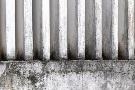 Aged concrete wall with vertical lines and weathered texture.
