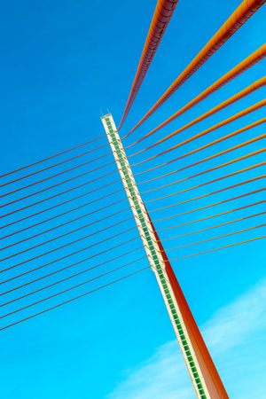 Abstract perspective of a modern cable-stayed bridge against blue sky.の写真素材