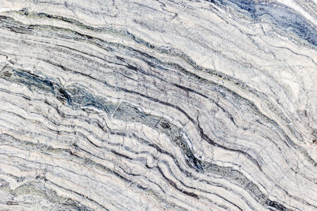 Natural marble texture with gray and white layered patterns.の写真素材
