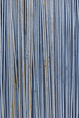 Close-up view of vertical steel rebars for construction projects.の写真素材