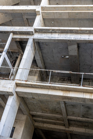 Industrial concrete construction site with exposed frame and multiple levels.