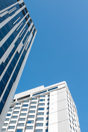 Modern skyscrapers against clear blue sky with geometric architecture.の写真素材