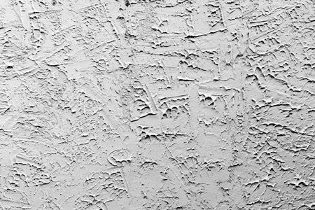 Textured gray stucco wall surface with rough plaster patterns.の写真素材