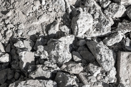 Pile of gray rocks and rubble in sunlight.の写真素材