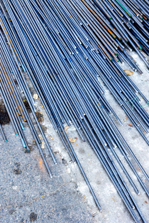 Stainless steel rebar rods arranged on concrete surface for construction.の写真素材