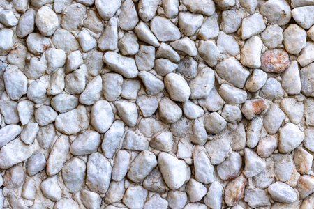 Close-up of white rocks creating a natural stone wall texture.の写真素材