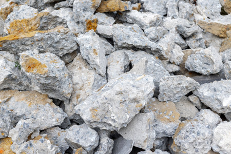 Close-up of broken concrete pieces in gray and beige tones.の写真素材