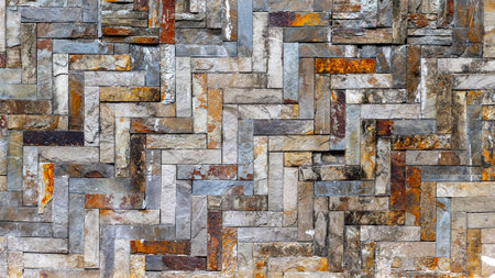 Rustic interlocking stone wall with geometric pattern and natural texture.の写真素材