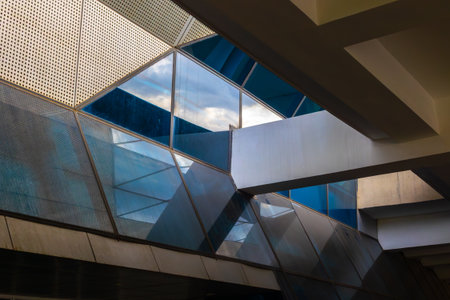 Modern geometric architecture with glass and steel reflections.の写真素材