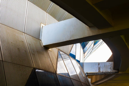 Modern architectural structure with geometric design and reflective surfaces.