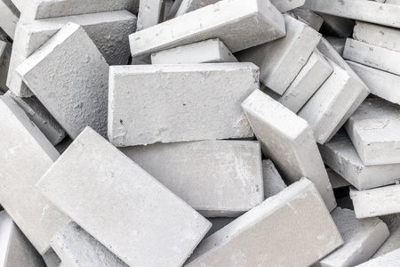 Pile of concrete bricks textured with rough surfaces for construction.の写真素材