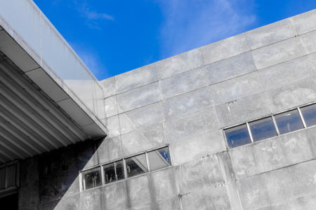 Modern industrial building with concrete walls and blue sky.の写真素材