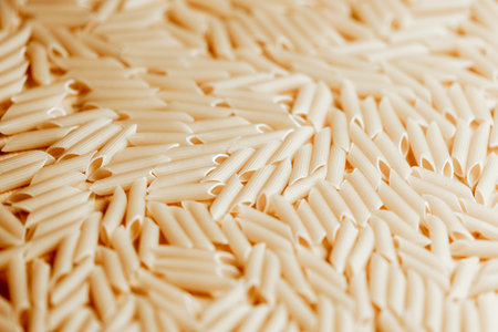 Close-up of uncooked penne pasta background.の写真素材