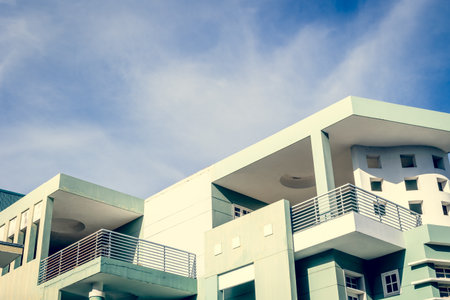 Modern architectural building with geometric shapes and blue sky background.の写真素材