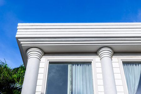 Neoclassical architecture with white columns and blue sky.の写真素材