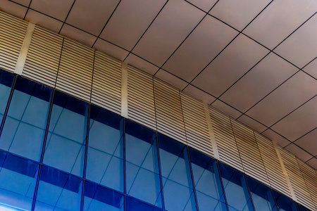 Modern architectural detail with glass and metal facade reflection.