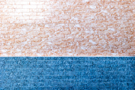 Abstract dual-toned brick wall with blue and beige textured pattern.の写真素材