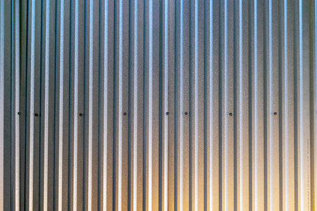 Vertical metal texture with industrial corrugated steel panels and subtle lighting.