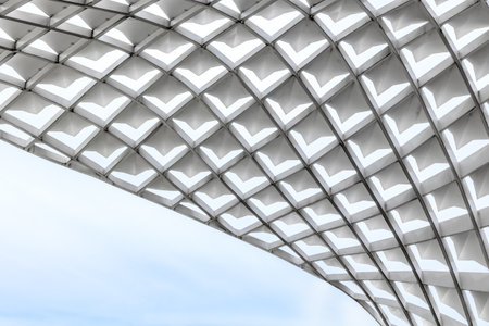 Modern architectural design featuring geometric patterned ceiling structure.の写真素材