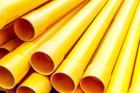 Close-up of bright yellow industrial pipes arranged diagonally.の写真素材