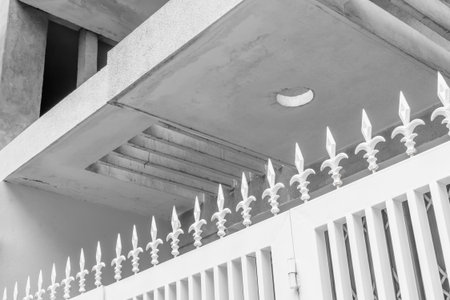 Modern architecture with decorative metal fence and concrete ceiling.の写真素材