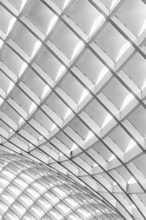 Abstract architectural ceiling with geometric patterns and natural light.の写真素材