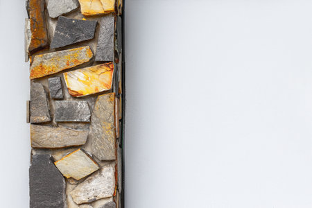 Stone wall with varied texture against plain white background.