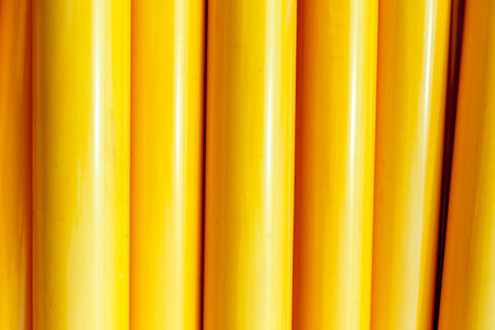 Bright yellow cylindrical patterns with shadows and highlights.の写真素材