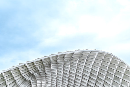 Modern architectural structure against blue sky with unique geometric patterns.の写真素材